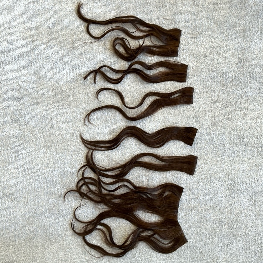 Synthetic clip on hair. Light brown with a bit of auburn color. 17 inches.
